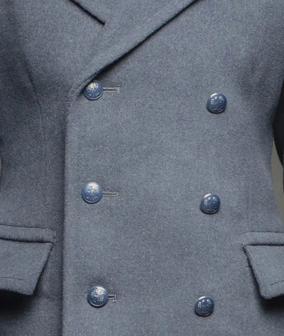 Close-up of blue gray Air Force officer overcoat with double-breasted buttons and front pockets