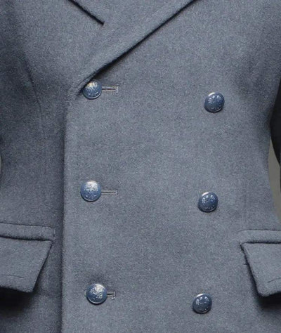 Close-up of blue gray Air Force officer overcoat with double-breasted buttons and front pockets