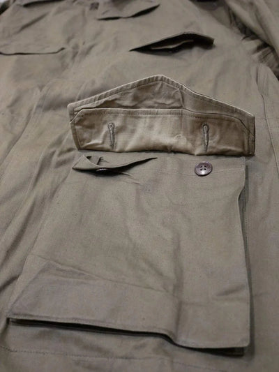 Close-up of green French Army M47 Sahara Desert jacket pocket with button flap and adjustable cuff details