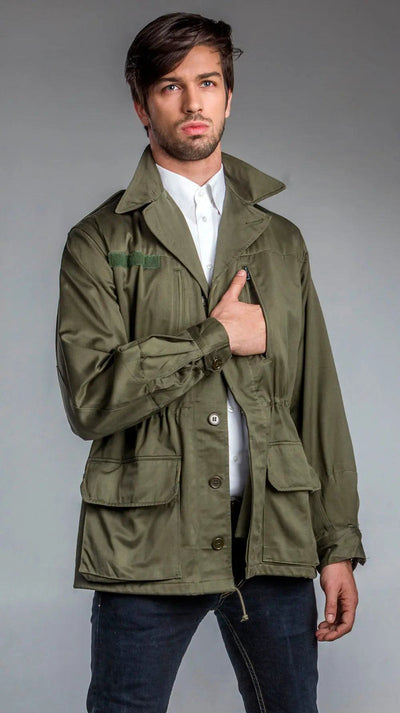Man wearing olive green M-64 Foreign Legion Field Jacket with button cuffs and spacious vertical pockets