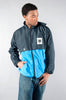 Retro 80s West German Puma windbreaker with German Army emblem, rollable hood, water-repellent, in blue and black.