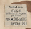 Fabric label with text and symbols on a camouflage background