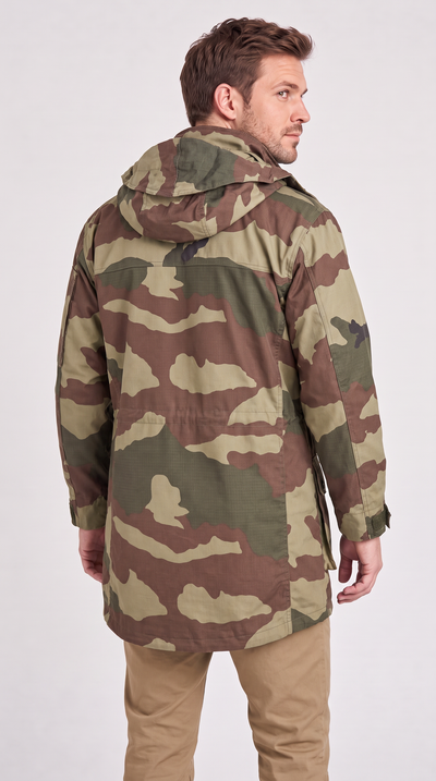 A man wearing a camouflage hooded jacket, shown from the back and side against a plain light gray studio background.