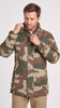 A man wearing a woodland camouflage jacket with a high collar and snap-button front, paired with khaki pants, against a plain light gray background.