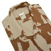 Camouflage shirt with a visible brand label on a white background