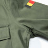 Green military-style shirt t with belgian flag patch on a white background