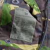 Clothing label on a camouflage hat with care instructions.