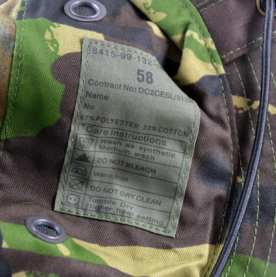 Clothing label on a camouflage hat with care instructions.