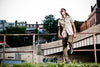 Man standing on a concrete ledge with urban background