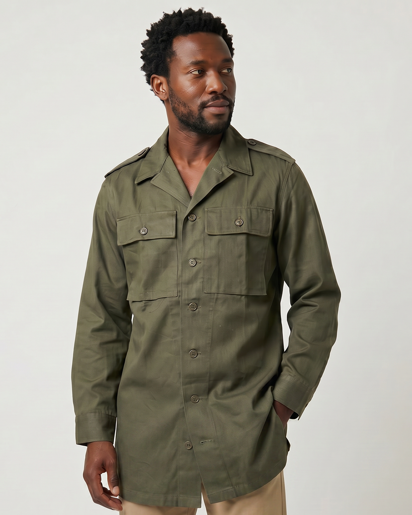 Man wearing a green hbt cotton twill mlitary shirt on a white background