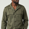 Man wearing a green jacket and beige pants on a white background