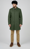 Man wearing a green coat, beige pants, and a black beret on a white background