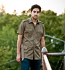 Man wearing Italian military brown safari style shirt with belt and four flap pockets outdoors