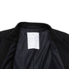 Black coat with a visible label on a white background