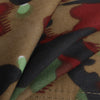 Close-up of camouflage fabric with brown, green, and red colors.