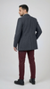 Man wearing a gray coat and burgundy pants on a white background