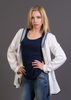 Woman posing in a studio setting with a British navy white and blue shirt with a gray plain background