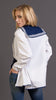 Woman wearing a white british royal navy cotton vintage shirt with blue accents and brown boots against a gray background