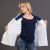 Woman holding a white vintage british Royal Navy shirt against a gray background