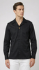 Man wearing a black long-sleeve shirt with a collar on a white background