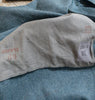 Close-up of a denim fabric with 'SCHWYZ 60' and a label on a blue denim background