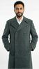 Man wearing a long dark green coat on a white background