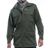Man wearing a green jacket and dark jeans on a white background